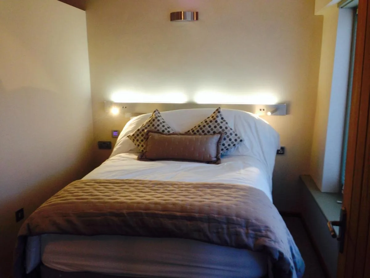 a bed in a room with two pillows on it at York Aparthotel in York