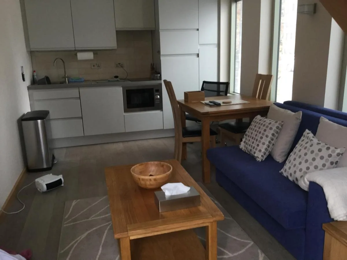 a living room with a blue couch and a table at York Aparthotel in York
